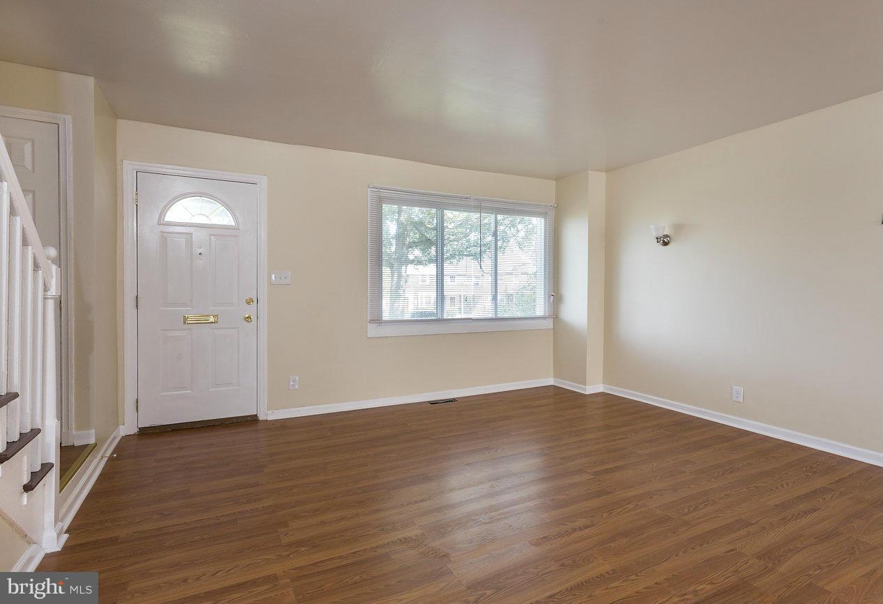 4658 Marble Hall Road Baltimore, MD 21239 - Photo 14 of 23 an empty room with wooden floor and windows
