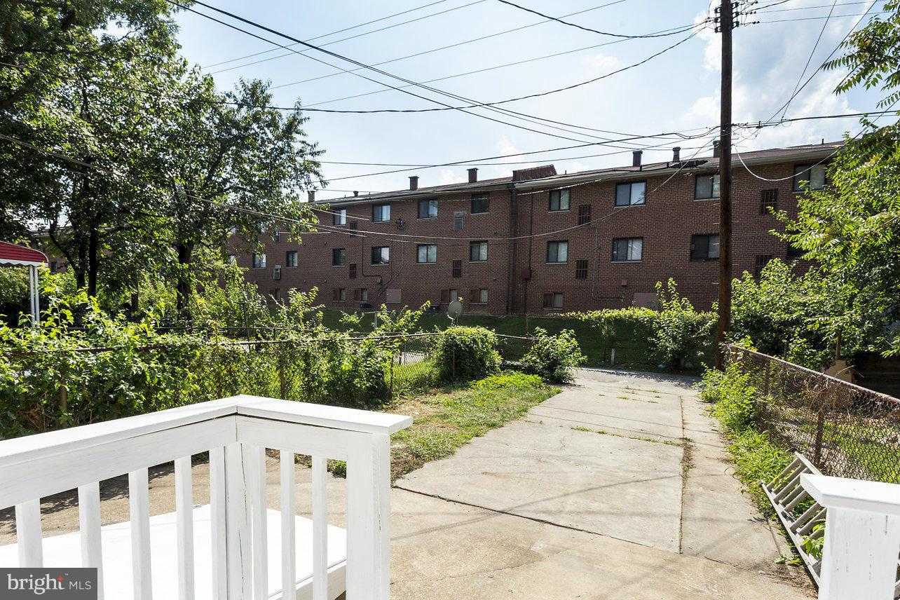4658 Marble Hall Road Baltimore, MD 21239 - Photo 15 of 23 a front view of a house with a yard