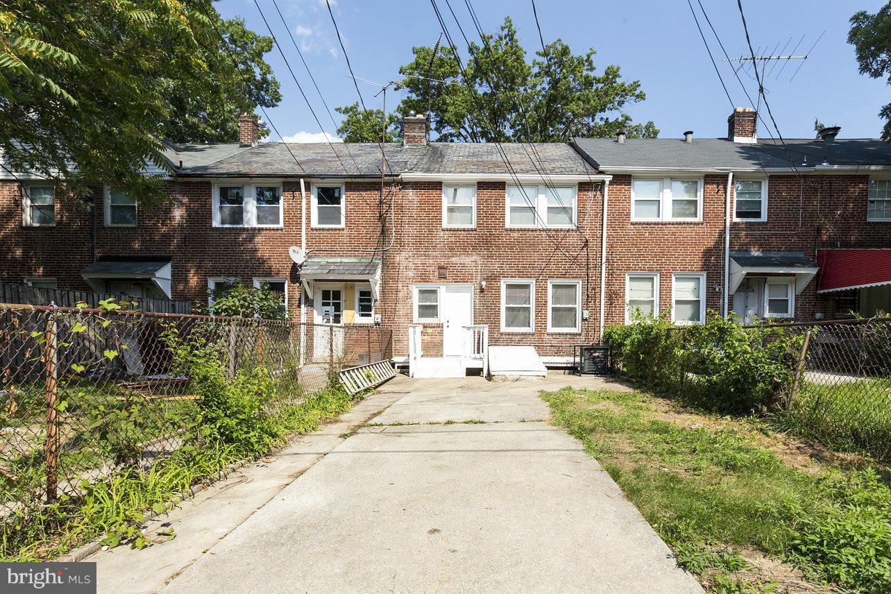 4658 Marble Hall Road Baltimore, MD 21239 - Photo 16 of 23 a front view of a residential apartment building with a yard