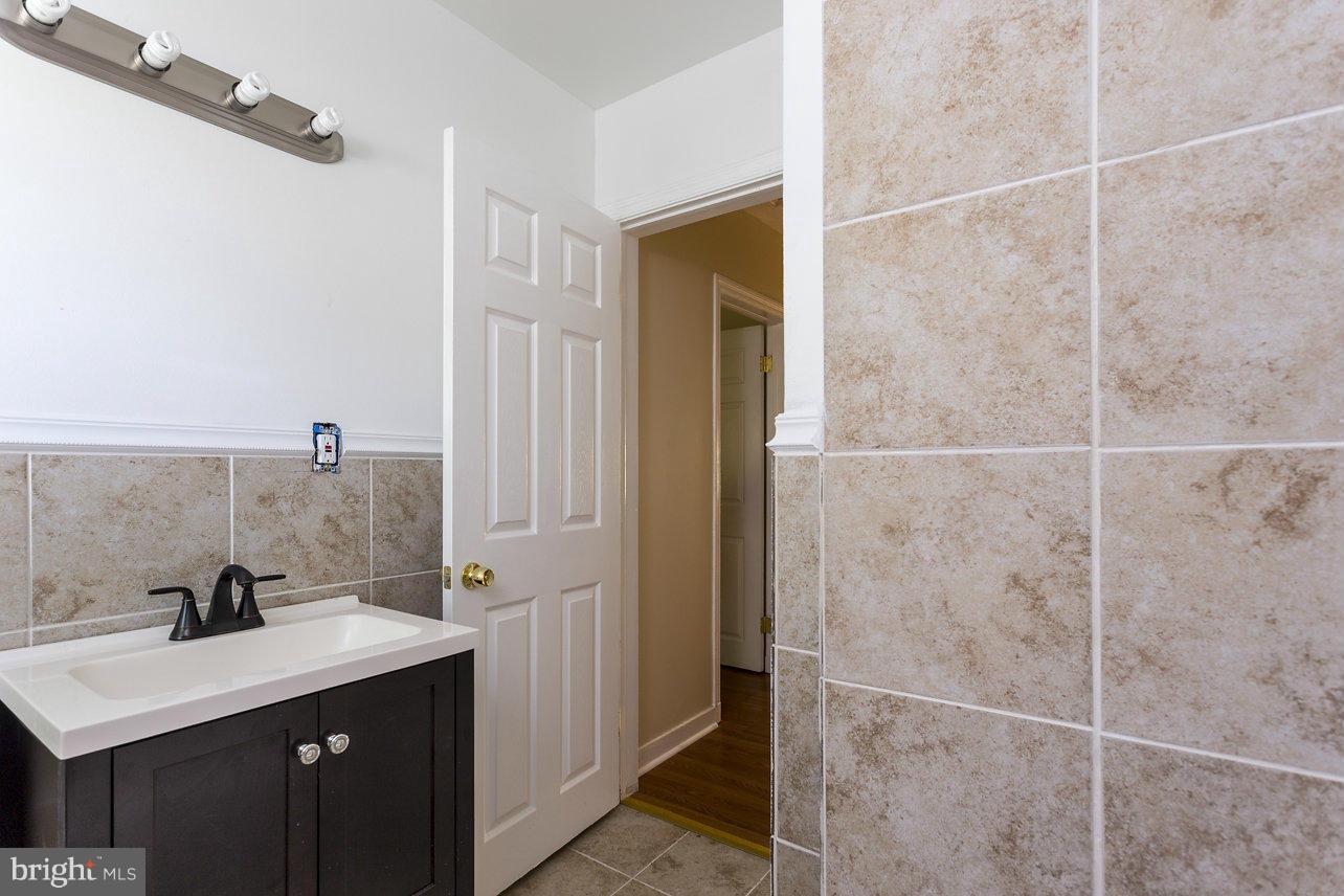 4658 Marble Hall Road Baltimore, MD 21239 - Photo 18 of 23 a bathroom with a sink and a mirror