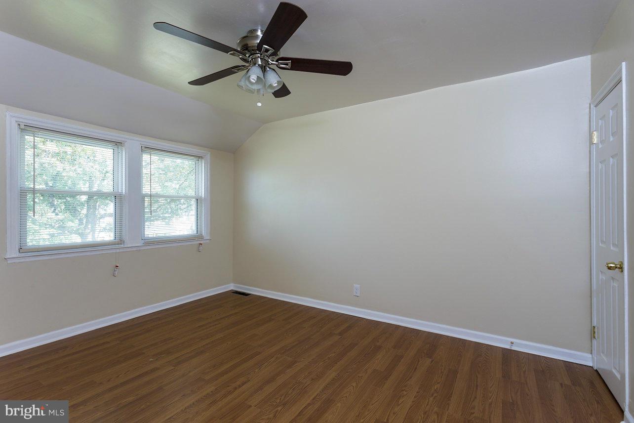 4658 Marble Hall Road Baltimore, MD 21239 - Photo 20 of 23 an empty room with a window and a fan