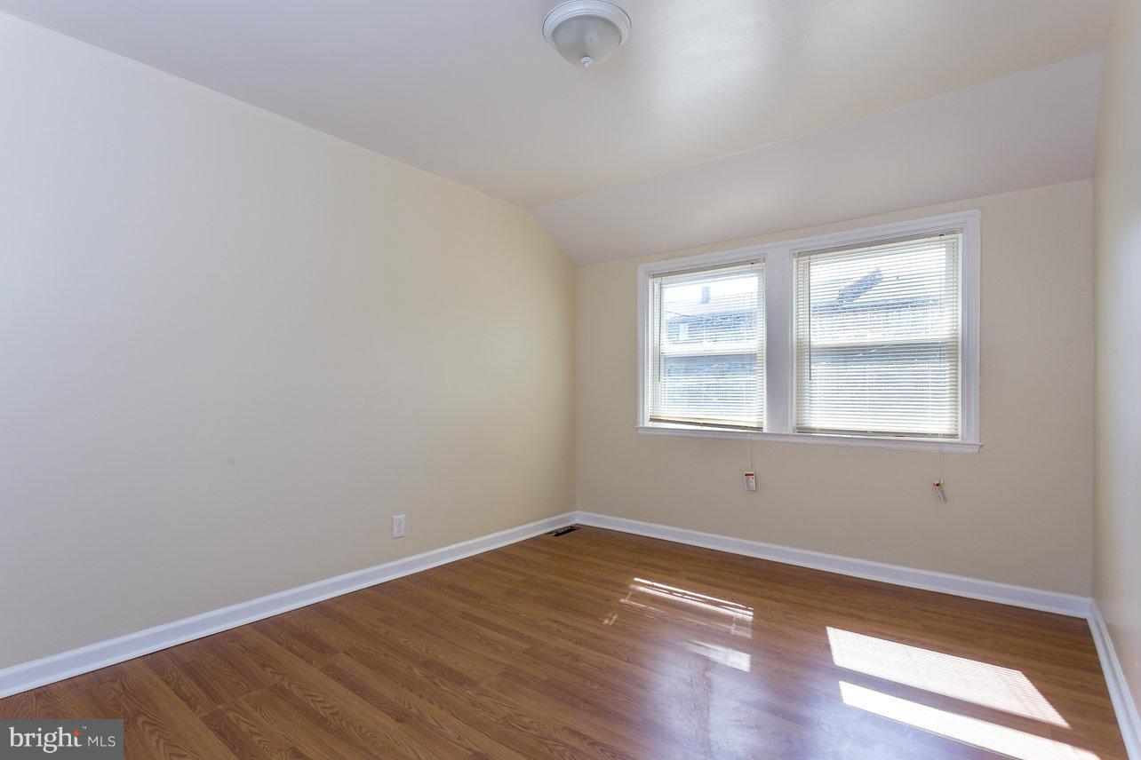 4658 Marble Hall Road Baltimore, MD 21239 - Photo 22 of 23 wooden floor in an empty room with a window