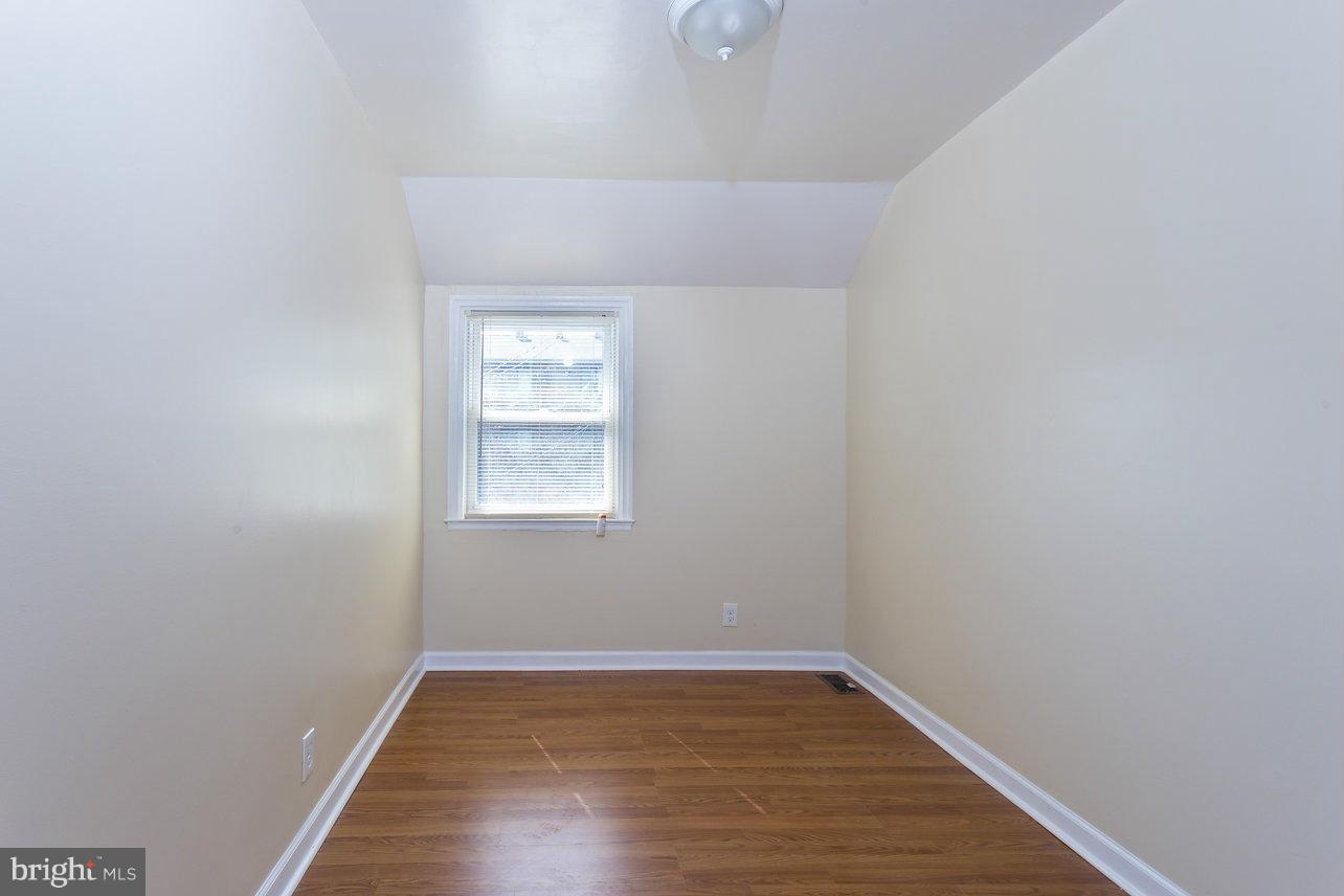 4658 Marble Hall Road Baltimore, MD 21239 - Photo 23 of 23 a view of an empty room with wooden floor and a window