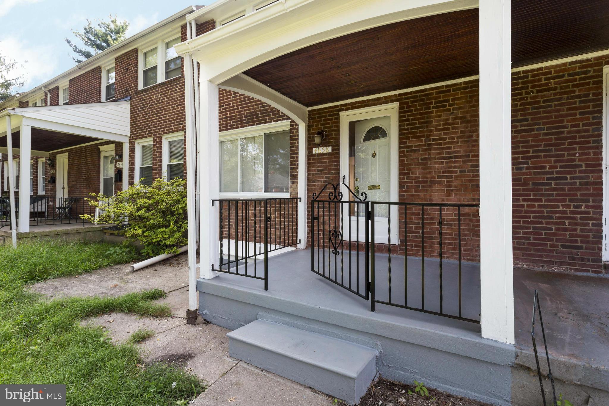 4658 Marble Hall Road Baltimore, MD 21239 - Photo 6 of 23 a view of a house with a small yard and wooden floor and fence