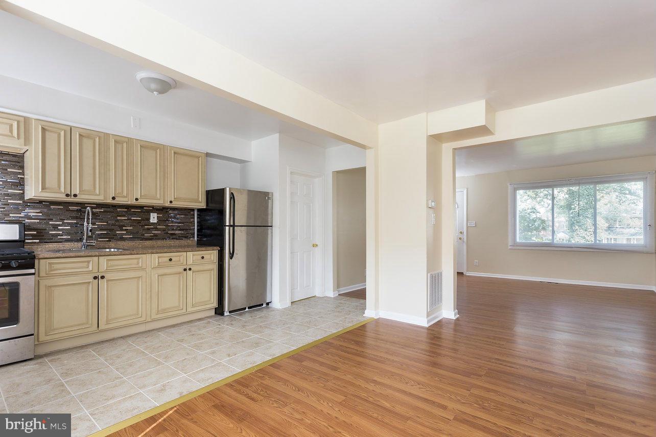 4658 Marble Hall Road Baltimore, MD 21239 - Photo 7 of 23 a kitchen with stainless steel appliances granite countertop a refrigerator sink and cabinets