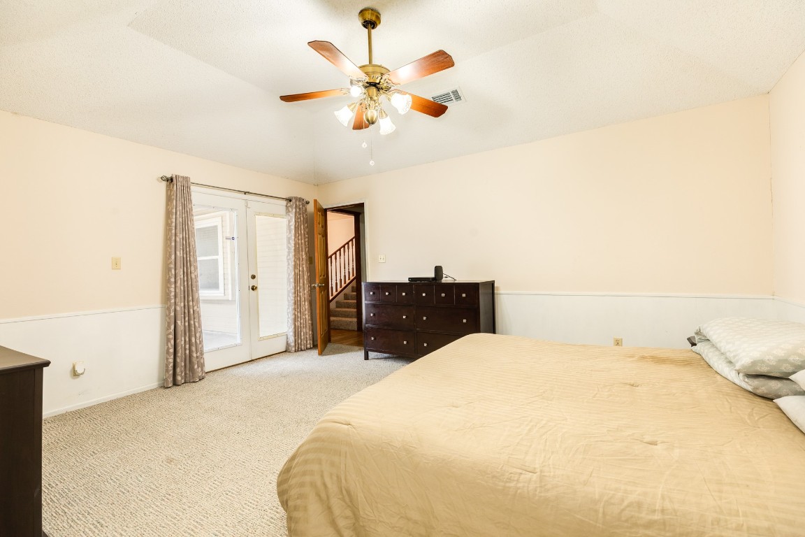 52 South Bachelor Button Street Lake Jackson, TX 77566 - Photo 15 of 45 a bed room with a bed and a ceiling fan
