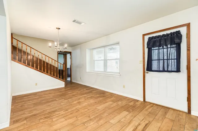an empty room with windows and closet