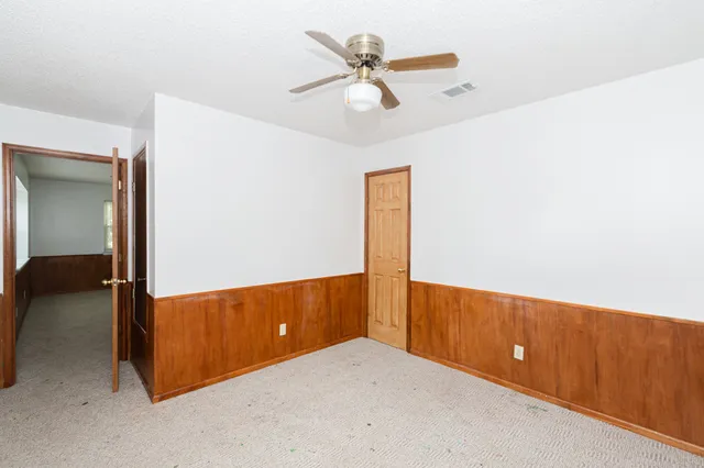a bathroom with a granite countertop window a toilet and a shower