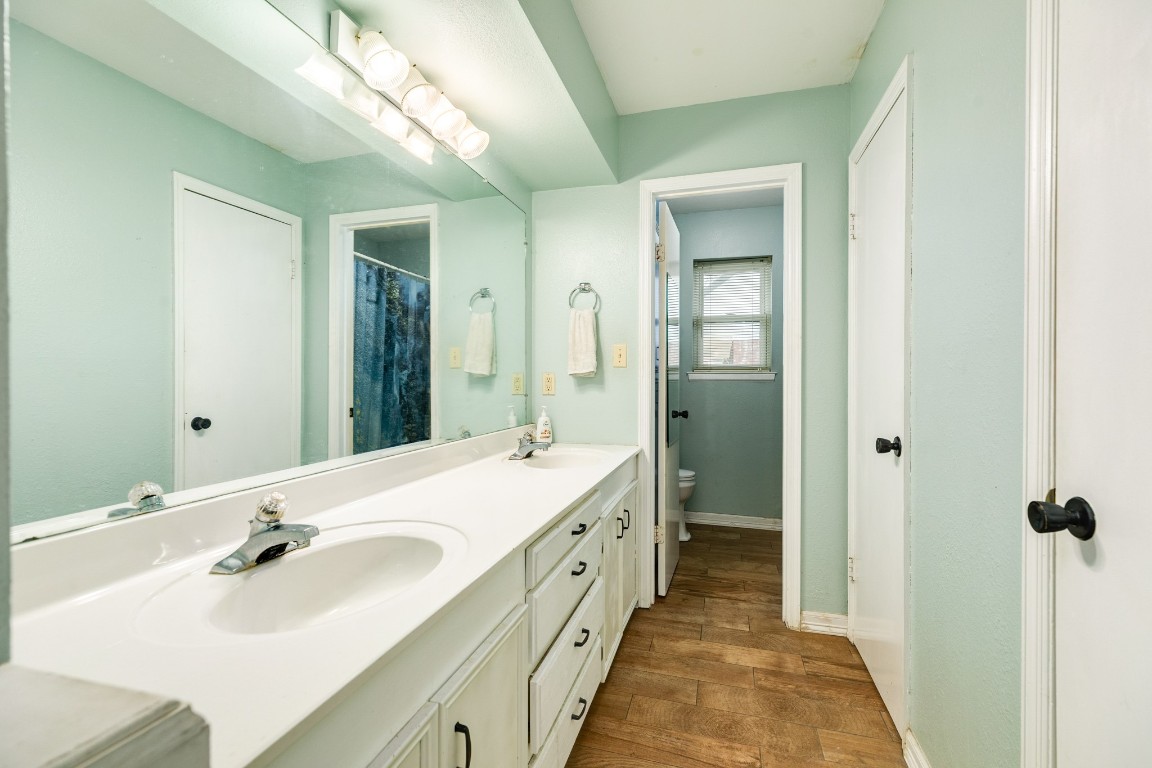52 South Bachelor Button Street Lake Jackson, TX 77566 - Photo 36 of 45 a spacious bathroom with a double vanity sink and mirror