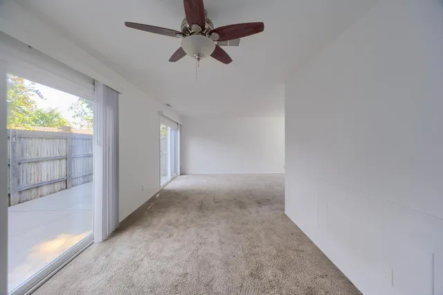 a view of an empty room with glass door