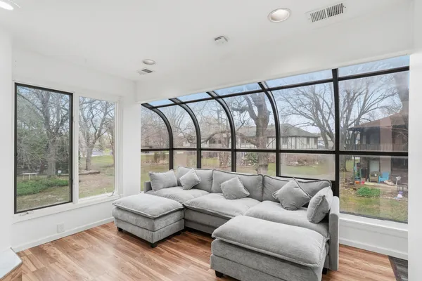 a living room with furniture and a large window with outer view