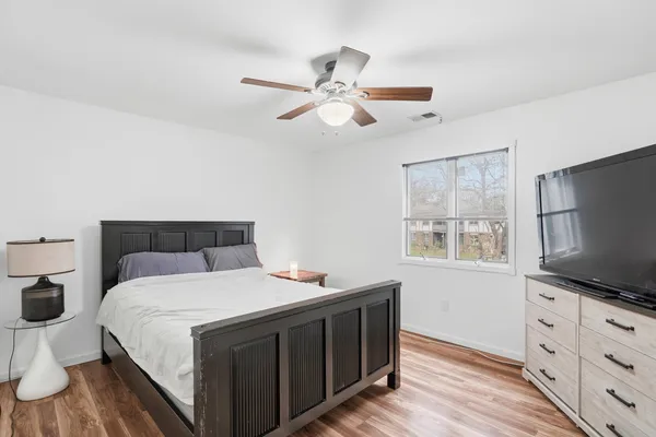 a bedroom with a bed and a flat screen tv