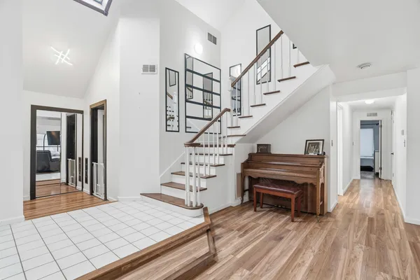 a view of entryway and hall with wooden floor