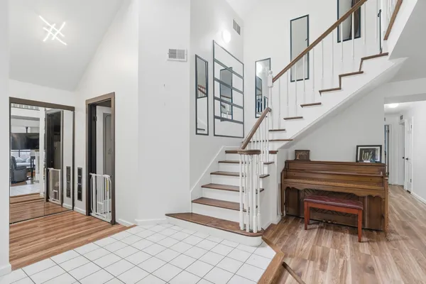 a view of entryway and hall with wooden floor