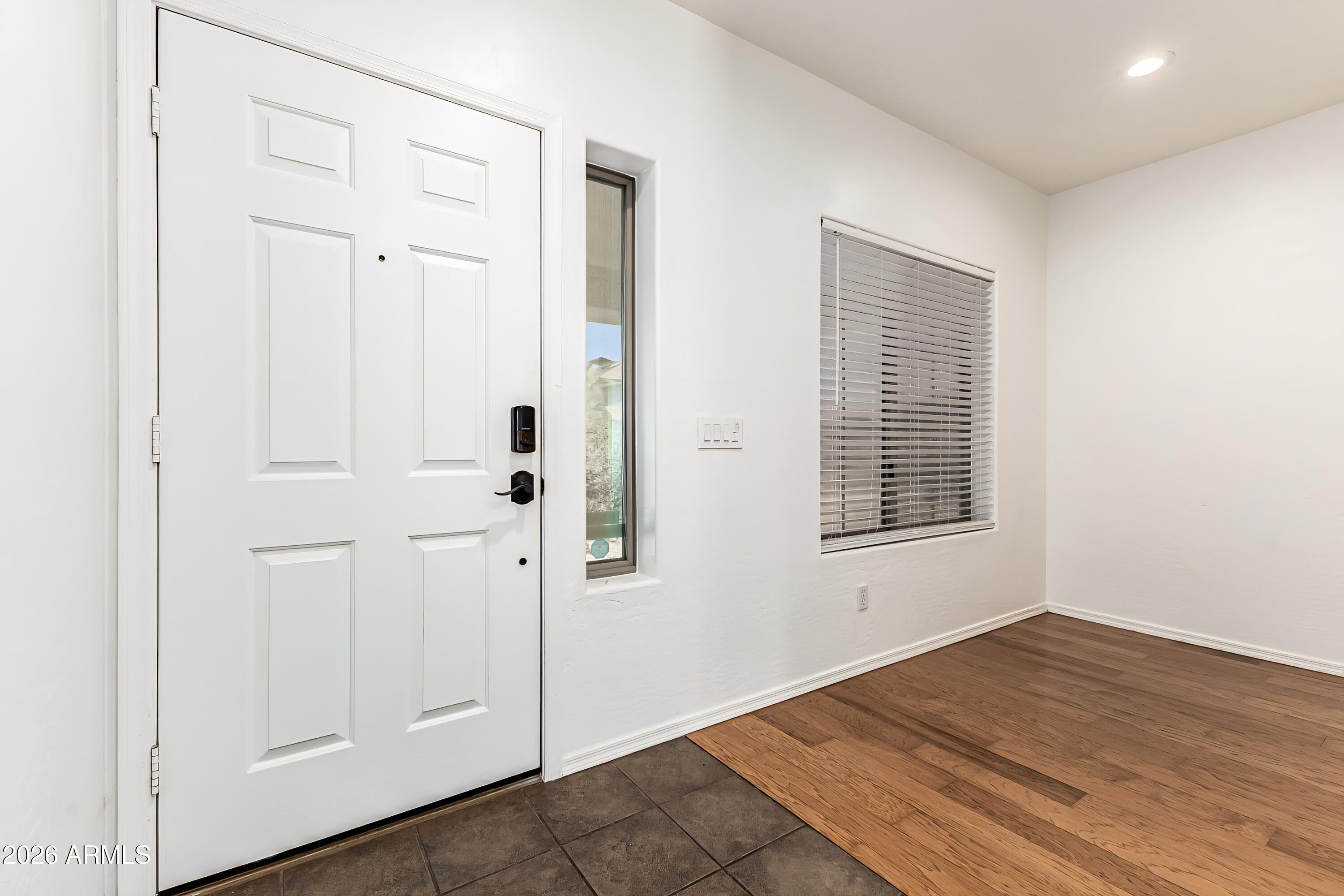4208 South Sawmill Road Gilbert, AZ 85297 - Photo 5 of 46 an empty room with wooden floor closet and windows