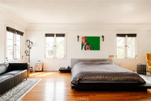 a bedroom with a large bed and a couch