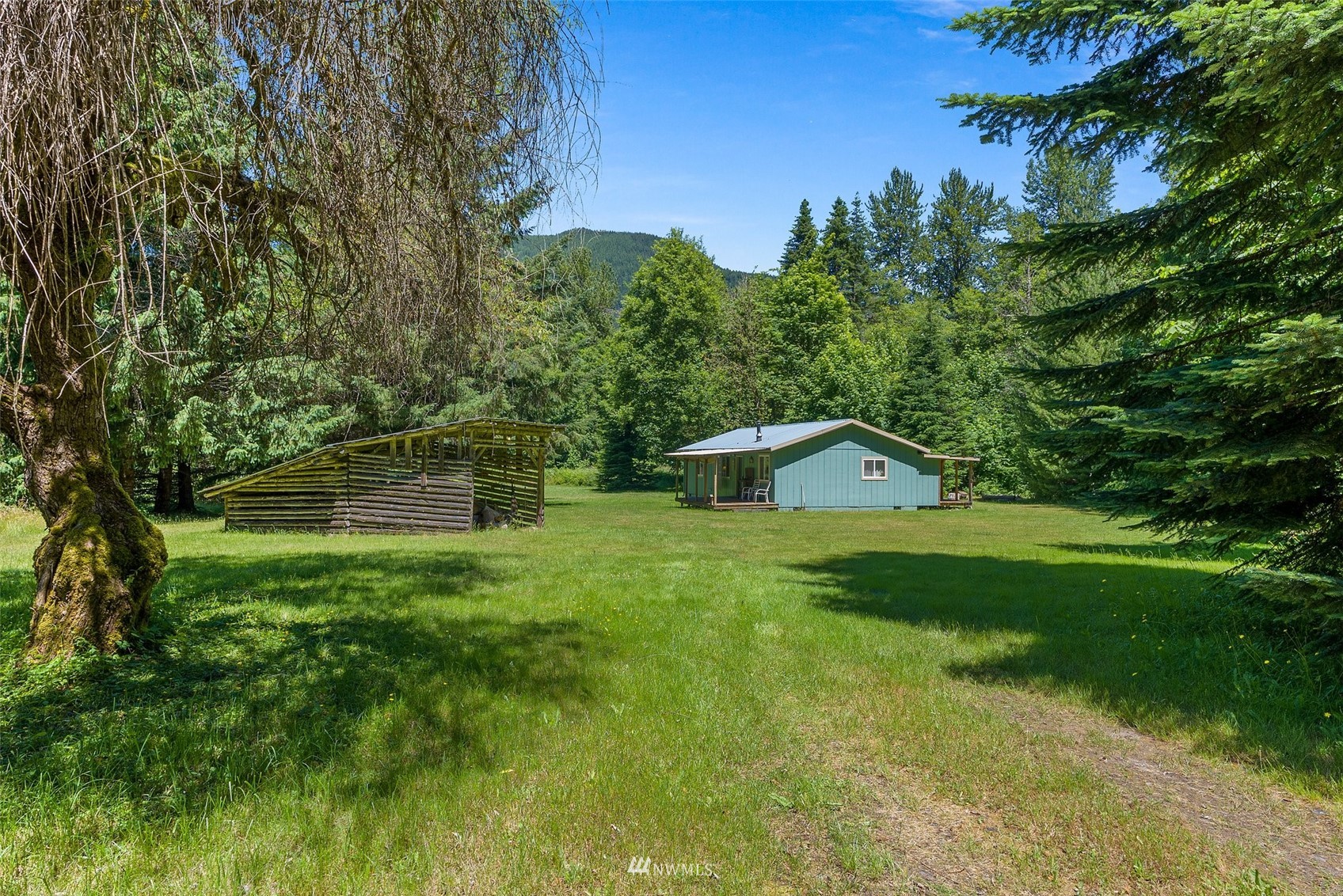 2158 Cispus Road Randle, WA 98377 - Photo 24 of 36 a front view of a house with a yard and trees