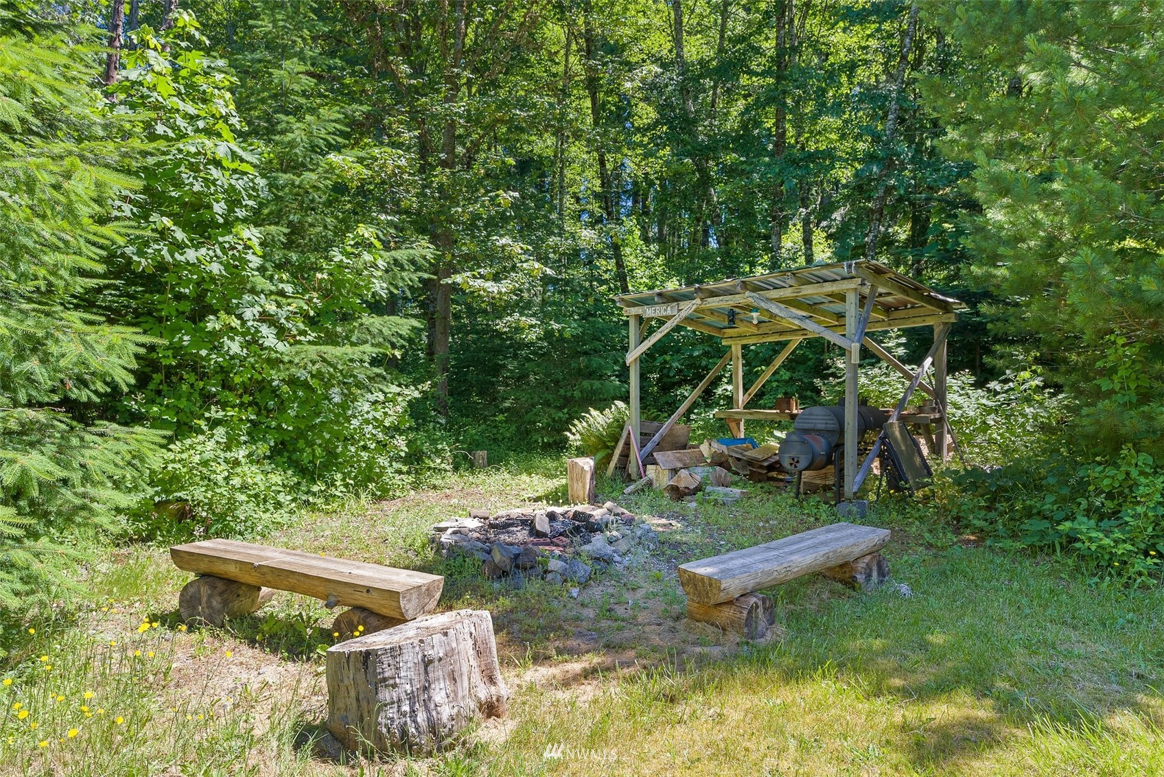 2158 Cispus Road Randle, WA 98377 - Photo 27 of 36 a view of a backyard with table and chairs under an umbrella