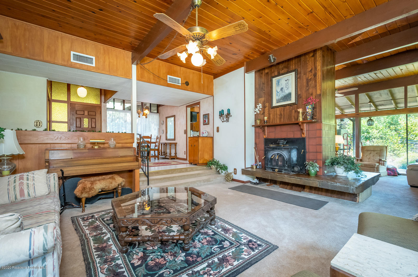 2311 Stonyvale Road Tujunga, CA 91042 - Photo 14 of 83 a living room with furniture a fireplace and a table