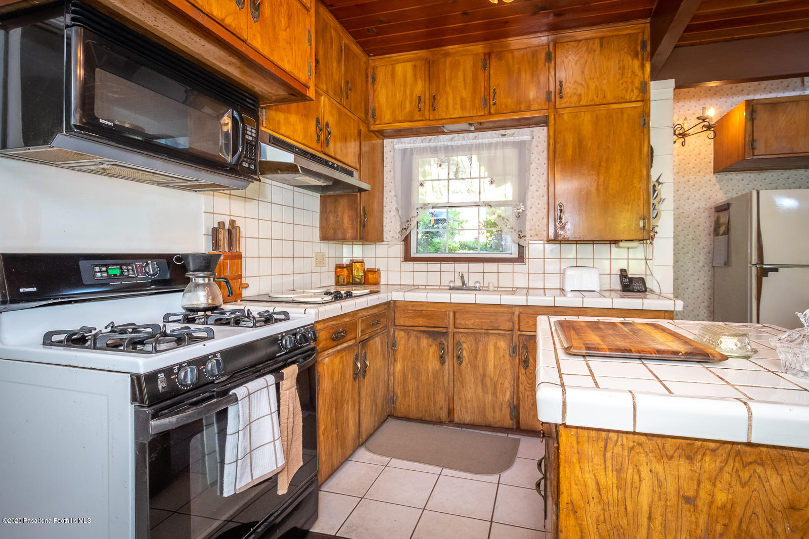 2311 Stonyvale Road Tujunga, CA 91042 - Photo 20 of 83 a kitchen with stainless steel appliances granite countertop a stove a sink and a microwave