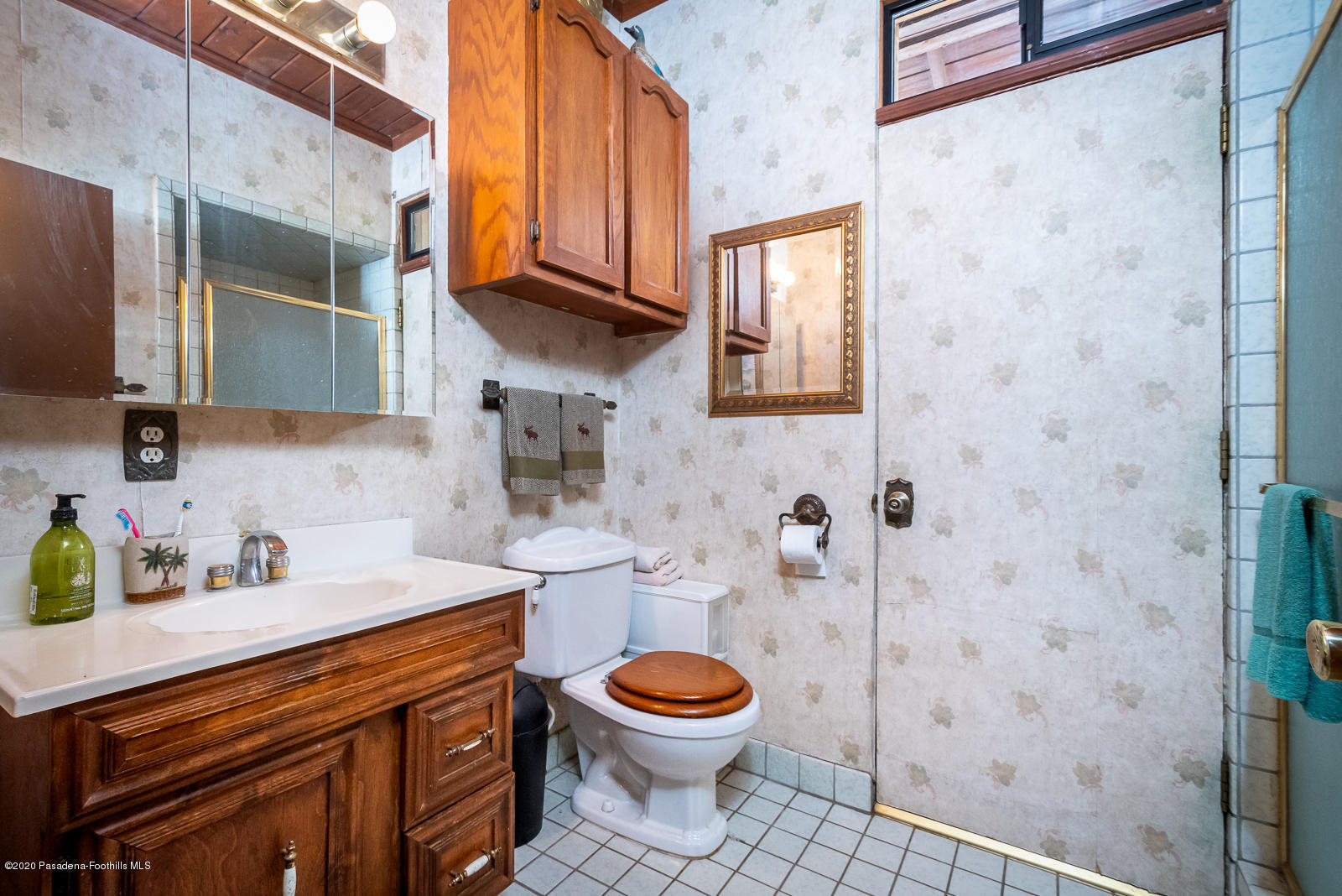 2311 Stonyvale Road Tujunga, CA 91042 - Photo 36 of 83 a bathroom with a granite countertop toilet a sink and a shower