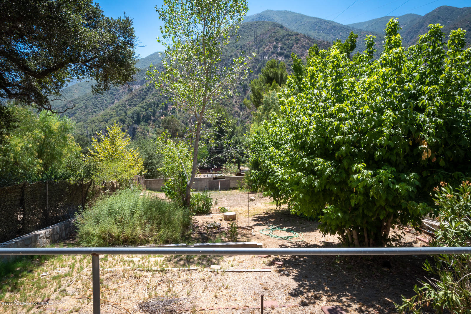 2311 Stonyvale Road Tujunga, CA 91042 - Photo 46 of 83 a view of a yard with plants and a bench