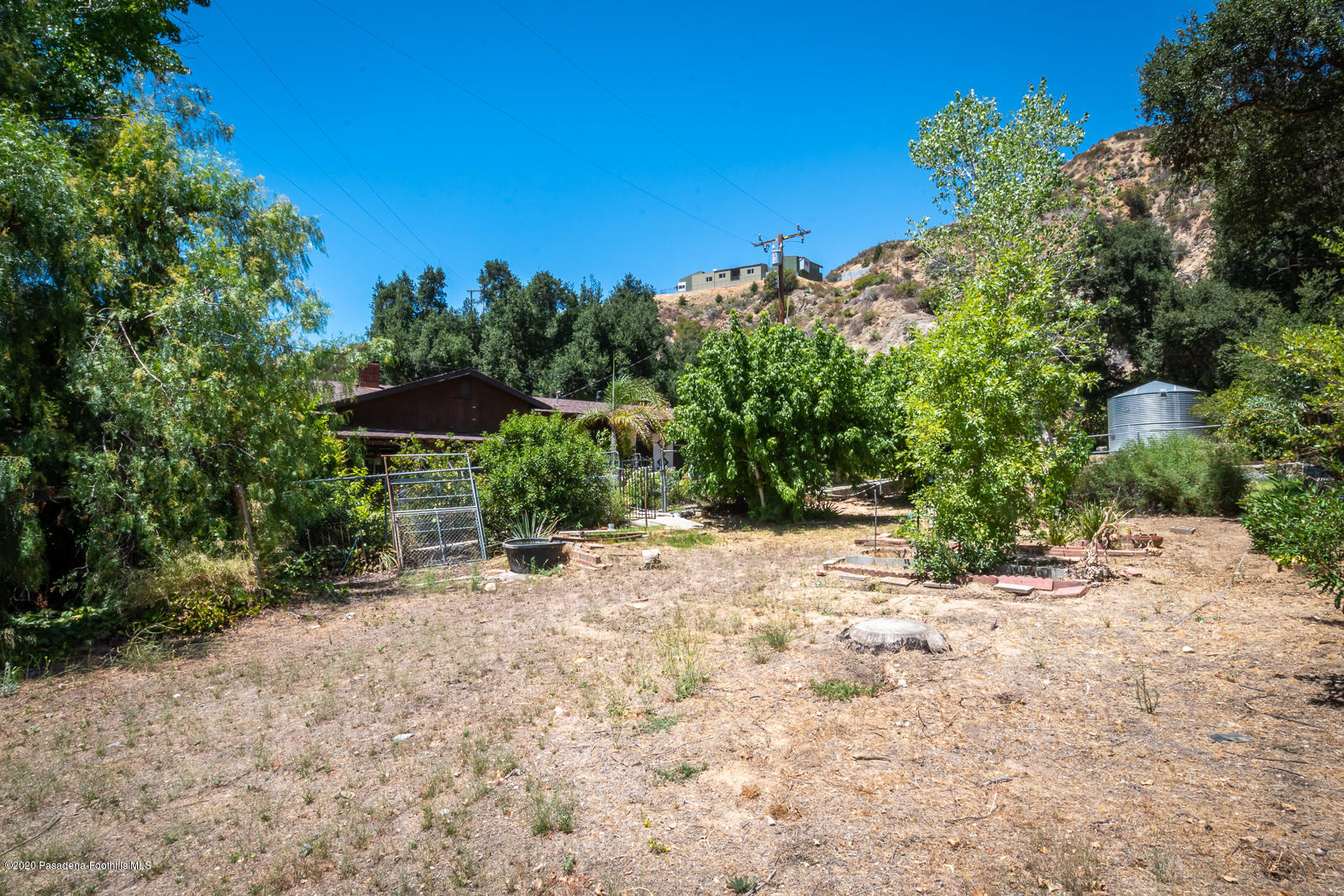 2311 Stonyvale Road Tujunga, CA 91042 - Photo 51 of 83 a view of a yard with a table and chair