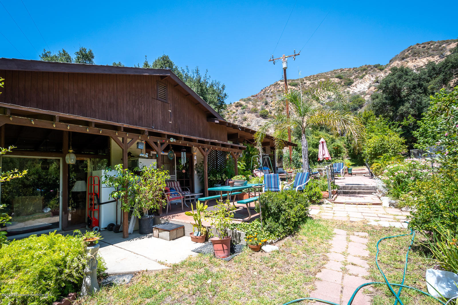 2311 Stonyvale Road Tujunga, CA 91042 - Photo 54 of 83 a view of a chair and tables in the patio next to a yard