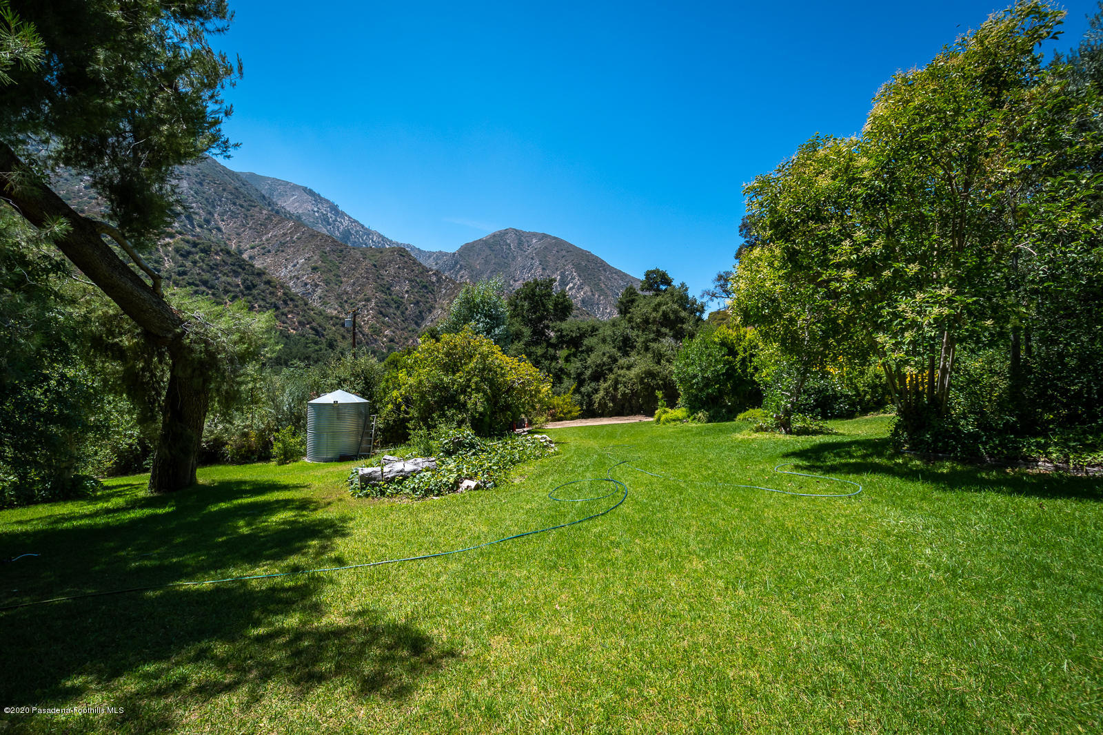 2311 Stonyvale Road Tujunga, CA 91042 - Photo 57 of 83 a backyard of a house with table and chairs