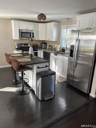 a kitchen with a sink a microwave a stove and refrigerator