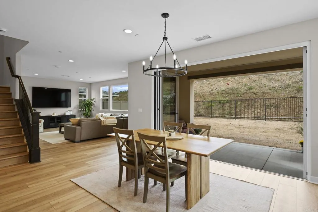 3015 Rue De Latour Vista, CA 92084 - Photo 11 of 48 a dining hall with couches a flat screen tv and kitchen view