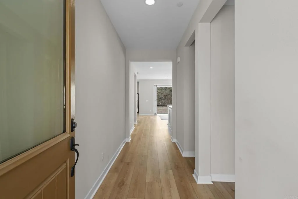 3015 Rue De Latour Vista, CA 92084 - Photo 17 of 48 a view of a hallway with wooden floor