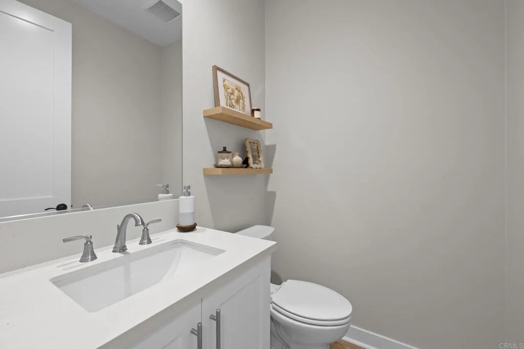 3015 Rue De Latour Vista, CA 92084 - Photo 18 of 48 a bathroom with a sink a toilet and a mirror