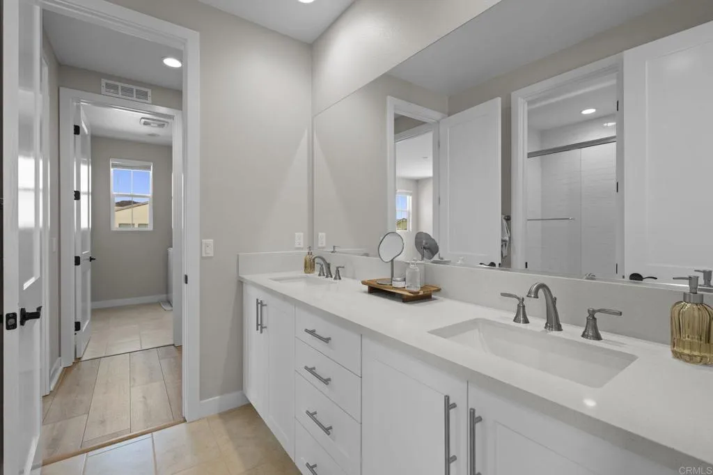 3015 Rue De Latour Vista, CA 92084 - Photo 31 of 48 a bathroom with double sink and a mirror
