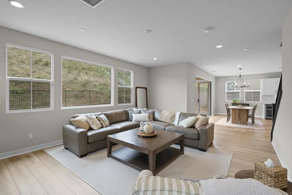 3015 Rue De Latour Vista, CA 92084 - Photo 7 of 48 a living room with furniture and floor to ceiling windows