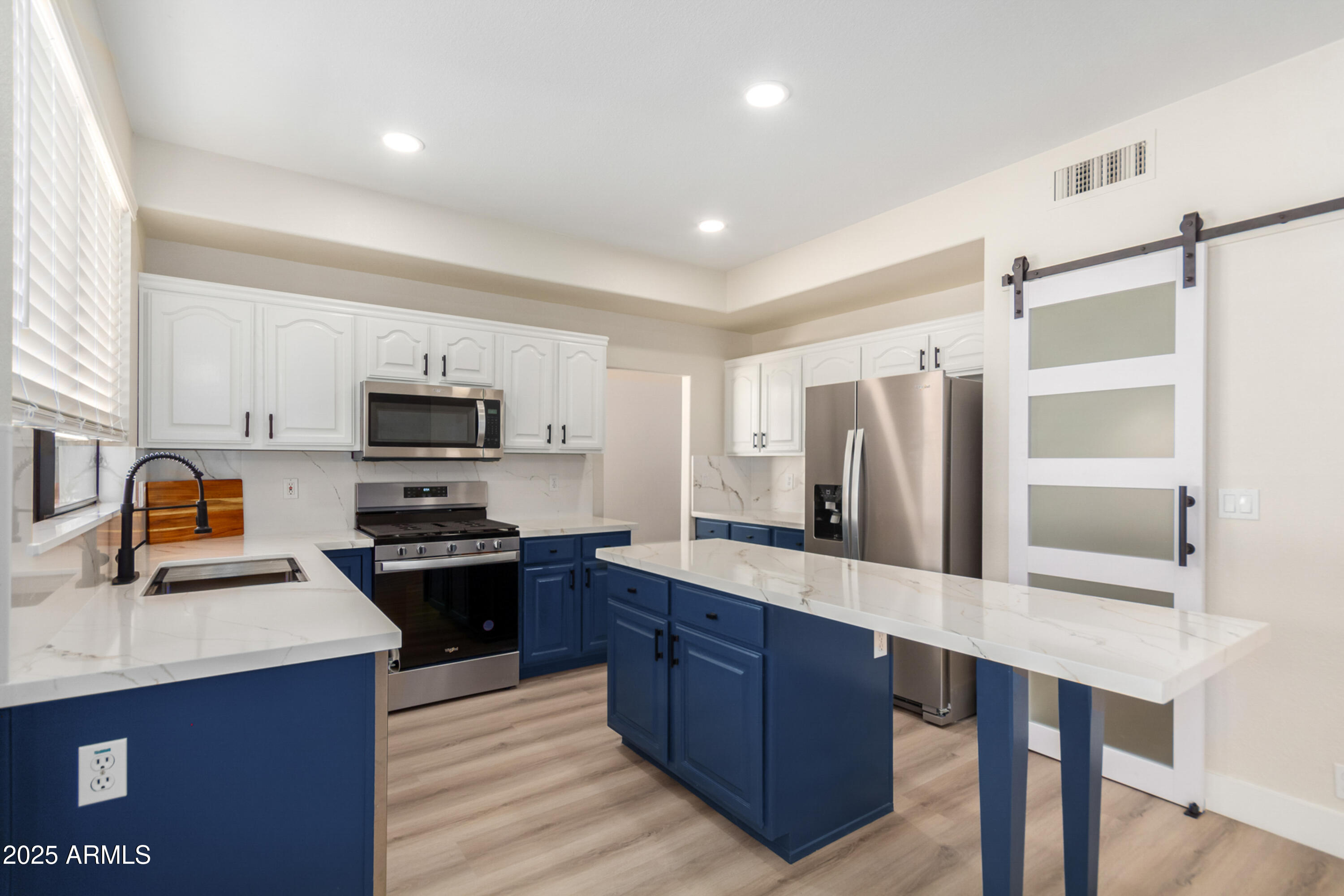 1630 South Lemon Mesa, AZ 85206 - Photo 11 of 55 a kitchen with stainless steel appliances a sink stove refrigerator and cabinets