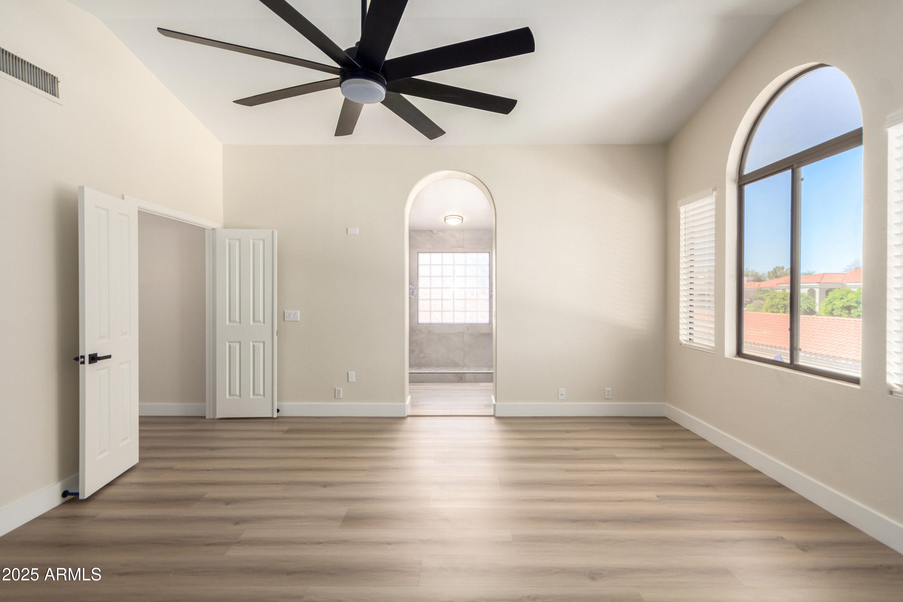 1630 South Lemon Mesa, AZ 85206 - Photo 27 of 55 an empty room with wooden floor fan and windows