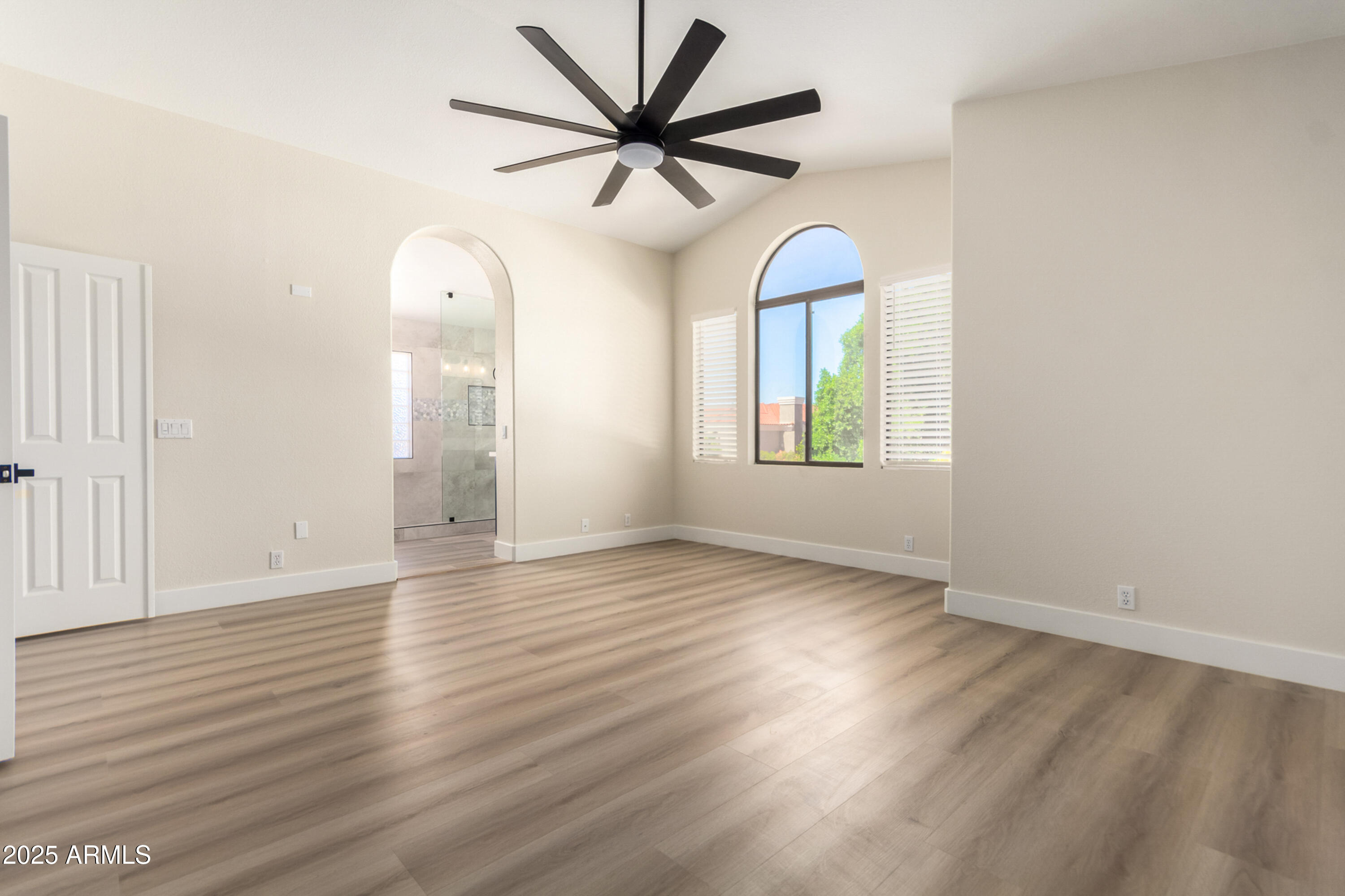 1630 South Lemon Mesa, AZ 85206 - Photo 29 of 55 an empty room with wooden floor chandelier fan and windows