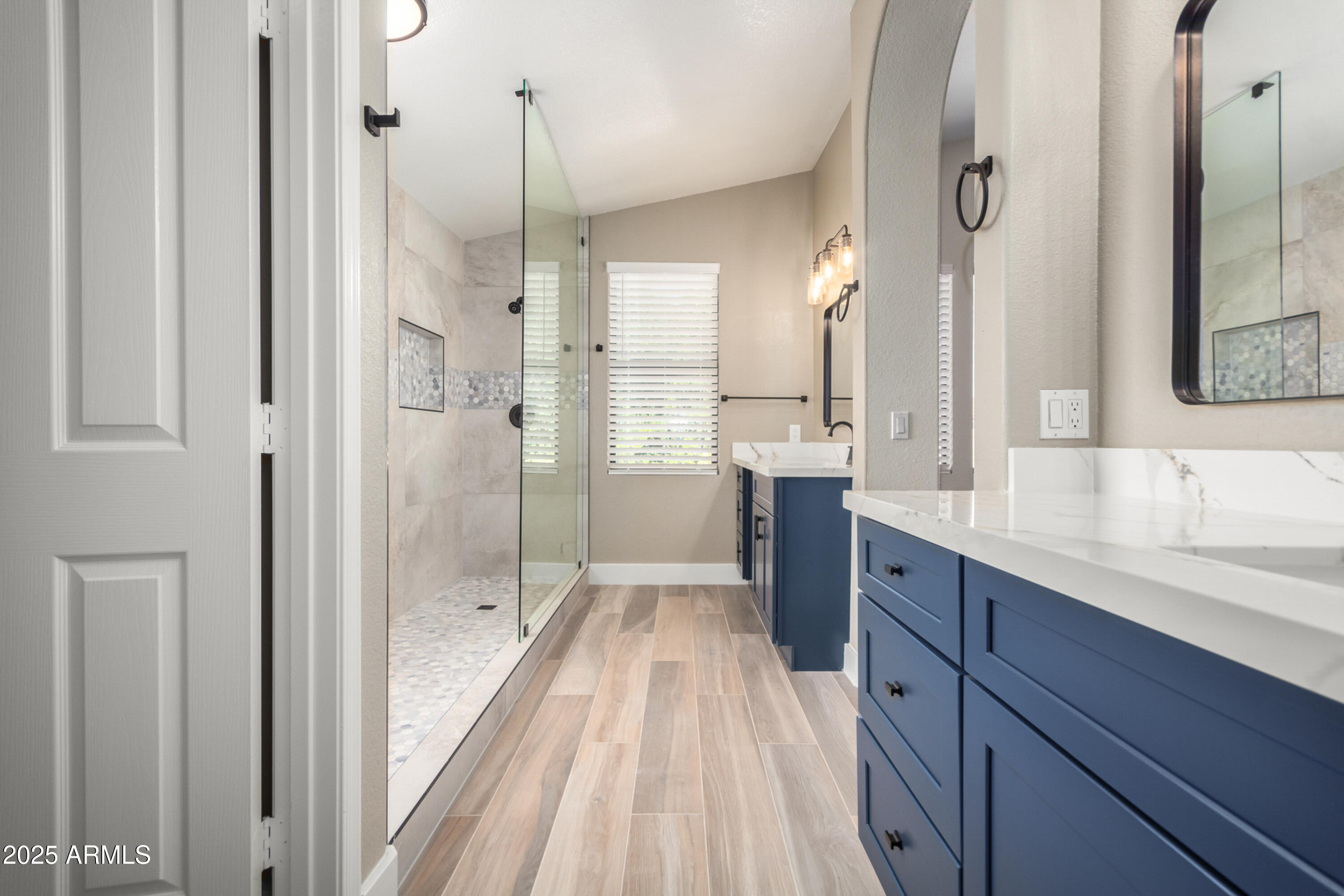 1630 South Lemon Mesa, AZ 85206 - Photo 7 of 55 a bathroom with a double vanity sink a mirror and a shower