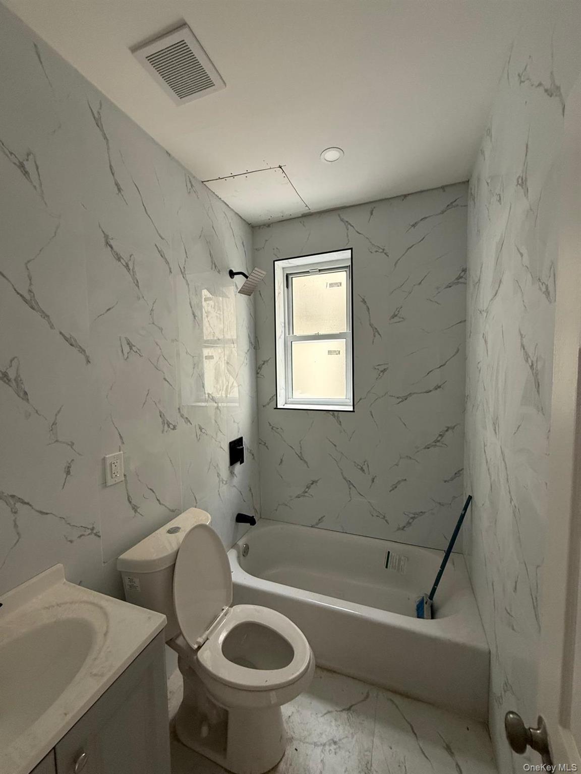 1335 Croes Avenue, Unit 2 Bronx, NY 10472 - Photo 2 of 5 a bath room with a toilet and a bath tub