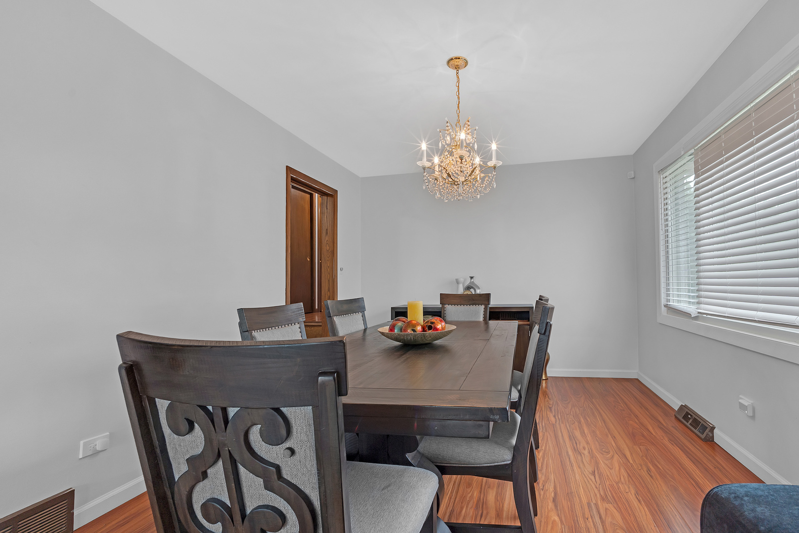 11020 Raleigh Street Westchester, IL 60154 - Photo 6 of 27 a view of a dining room with furniture wooden floor and chandelier