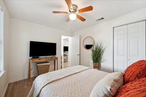 a bedroom with a large bed and a chandelier