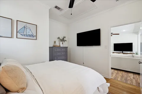 a bedroom with a bed and a chandelier