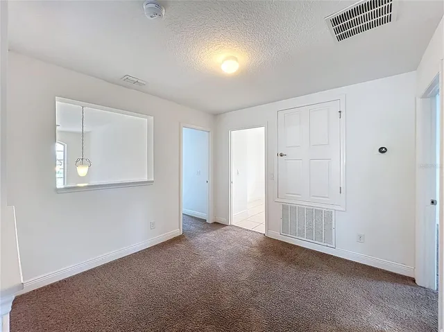 a view of a big room with windows and cabinet