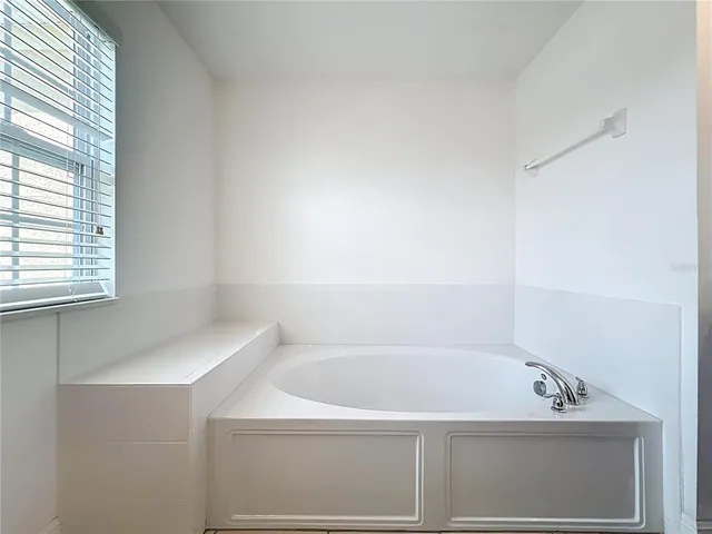 a bathroom with a tub and a shower