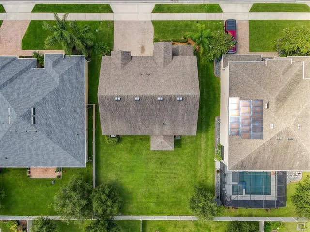 an aerial view of a city with lots of residential buildings and mountain view in back