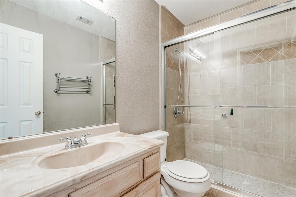 4232 Briarbend Road Dallas, TX 75287 - Photo 15 of 20 a bathroom with a granite countertop sink toilet and shower