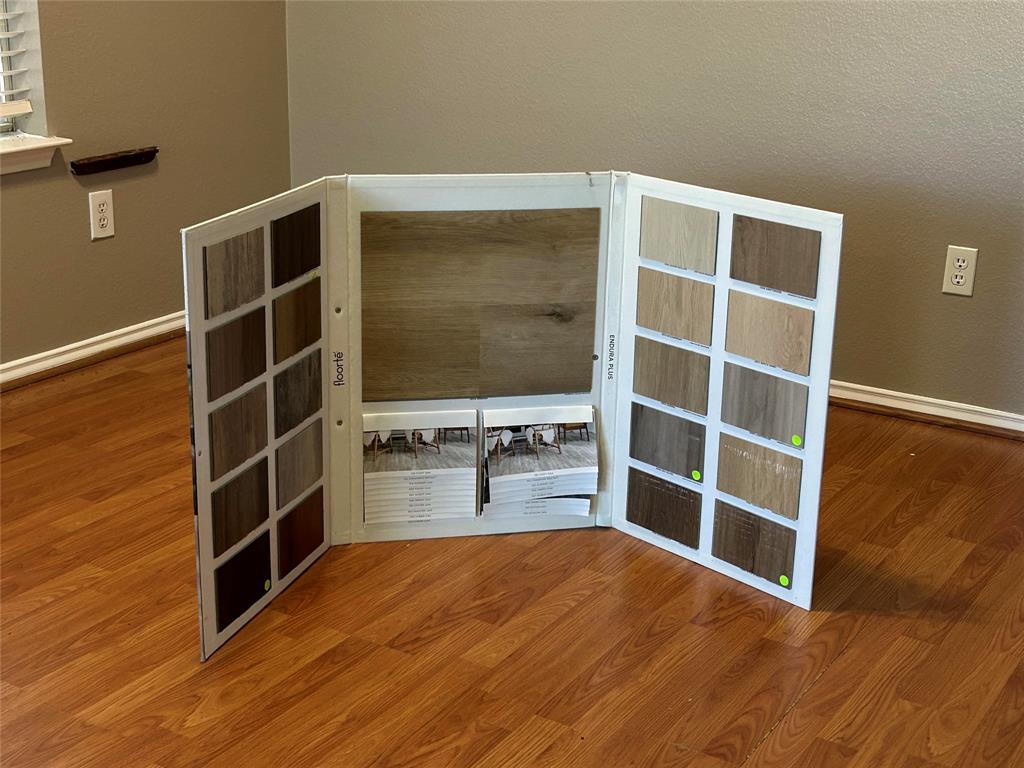 4232 Briarbend Road Dallas, TX 75287 - Photo 20 of 20 Spare room featuring wood finished floors and a textured wall