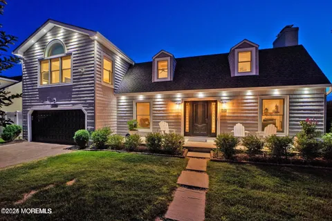a front view of a house with a yard and street view