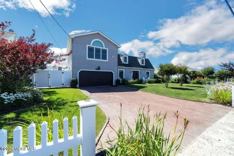 a spacious bedroom with a bed and a flat screen tv